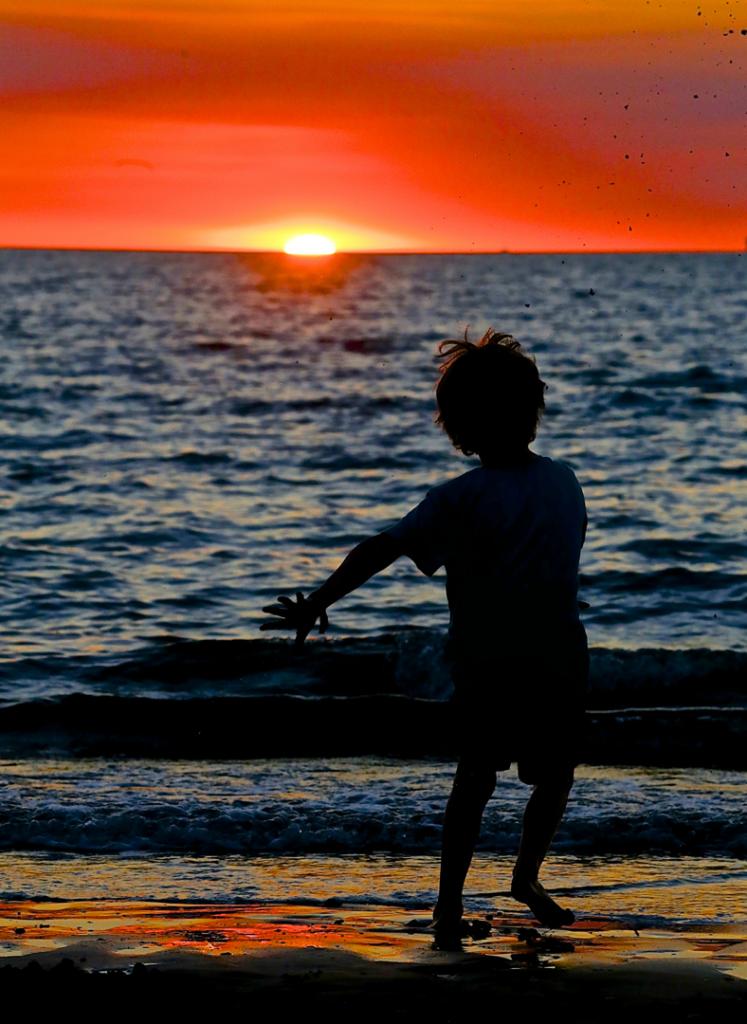 Boy Dancing to a Darwin Sunset by Helen Ansems
